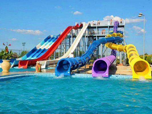 Le parc aquatique La piscine Attraction Les enfants jouent au toboggan en fibre de verre